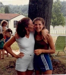 elly swartz and her mother are hugging in front of a tree